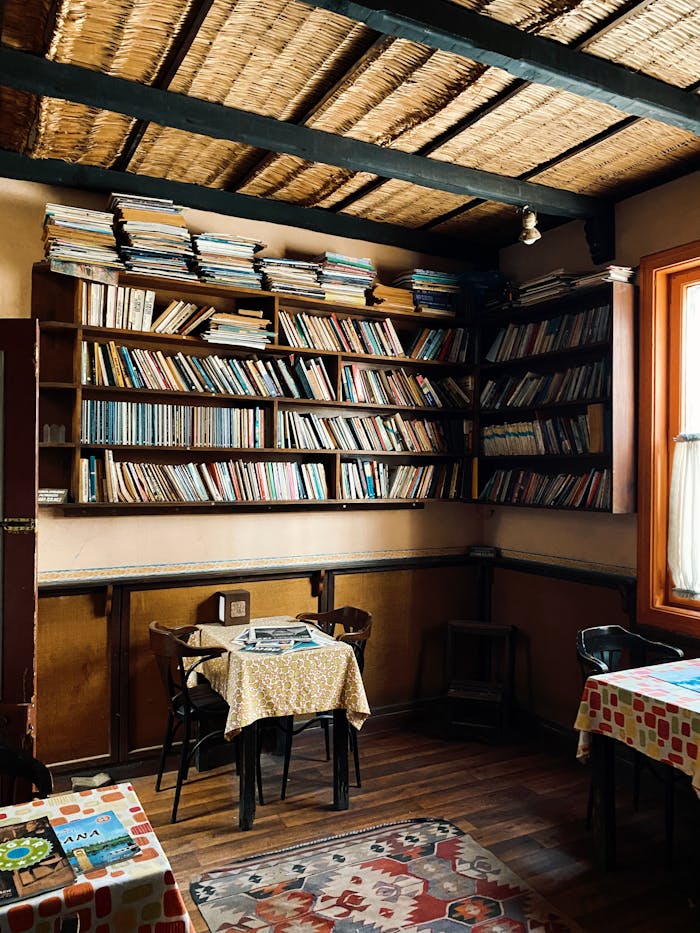 Warm-toned library interior with packed shelves and cozy reading tables for a relaxed reading atmosphere.